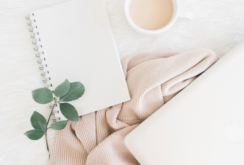 Minimal flat lay of computer and notebook. Marketing predictions for 2026