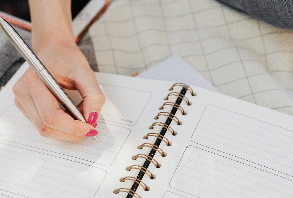 Women writing in planner too busy to take on more work