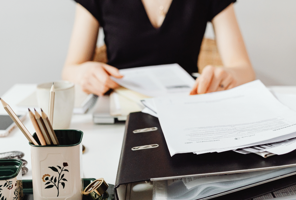 Women sitting at messy desk, when marketing feels overwhelming