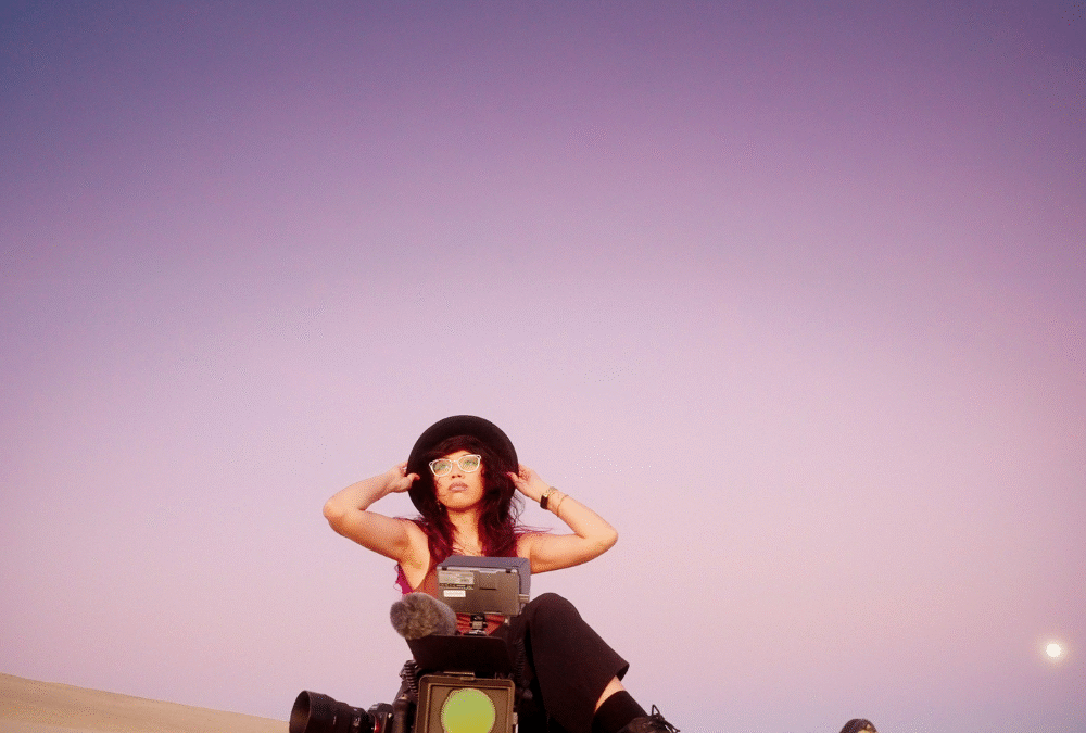 Sierra Miller of Caravan Content sits a top an Oregon Dune. Business pivot and rebranding.